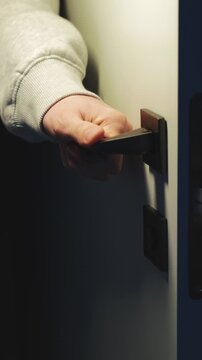 A man's hand opens the door to the convent