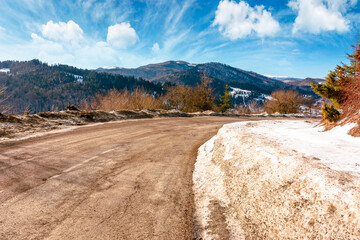 country road winding through winter landscape under blue sky. great bereznyi district of carpathian mountains on a sunny day. scenic view of uzhanian pass. travel background with snow covered slopes
