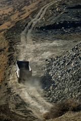 Dump Truck and Excavator at Mountain Road Construction Site
