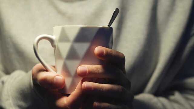 A man holds a white ceramic cup.
A hot drink in a beautiful, stylish cup.
Cup, drink, water, liquid