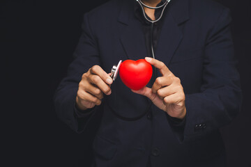 Doctor holding red heart with stethoscope for healthcare concept