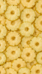 Refreshing pineapple slices arranged in a decorative yellow circle. Perfect for tropical themed designs, food blogs, summer designs, and healthy lifestyle content.