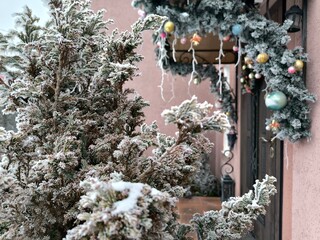 Porch of the house, beautifully decorated with Christmas tree decorations, and the trees covered with frost