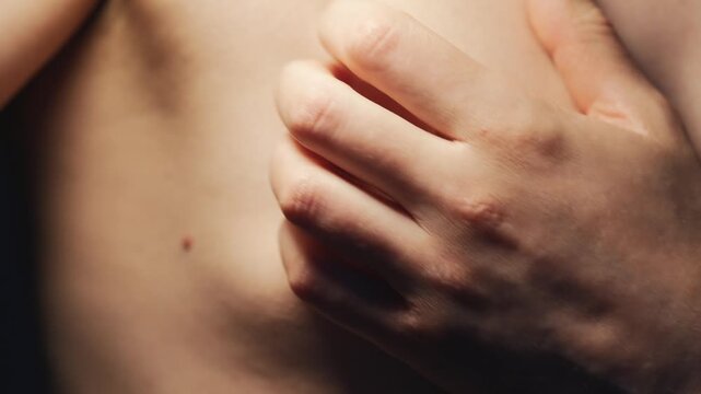 A man scratching his chest.
A close-up of the areola on a man's chest.
Anatomy and body parts.
The naked male body.
Gender differences between men and women.
