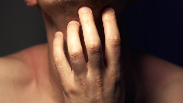 A close-up of an itchy neck.
A person scratching their throat with their nails, experiencing discomfort and allergies.
Allergic reaction and itchy skin after shaving