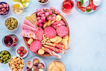Italian Antipasti. Charcuterie platter with cheese and other snacks, with wine, overhead flat lay shot with copy space