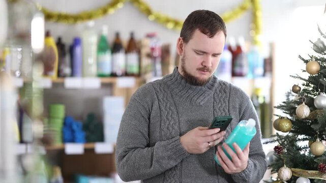 Man scan barcode on shower gel label and follows link to view product in Xmas atmosphere. Customer receives additional information about product using mobile application