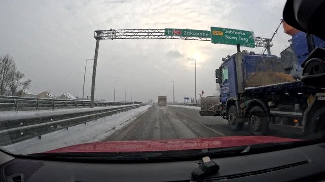 Traffic on a snowy highway as vehicles navigate winter conditions in December