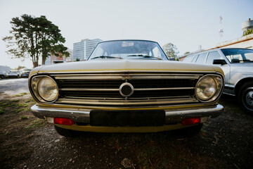 Front view of a vintage car in a parking lot