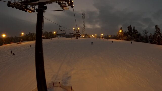 Snowboarding at night on a ski slope in winter