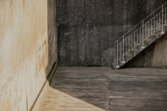 Concrete stairway with textured walls and shadows