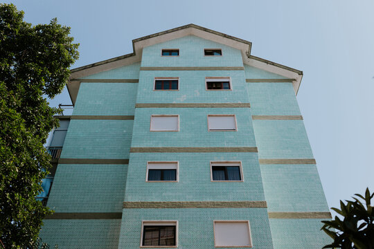 Modern blue residential building under clear sky