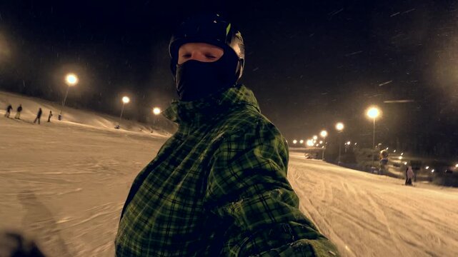 Night skiing at local slope with snowboard and winter gear