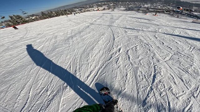 Snowboarding on a mountain slope during daytime in winter