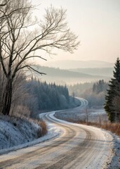 A snowy winter road winding through a mountain forest under a cold white sky