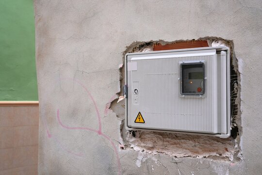 Electricity meter box mounted on house wall in Cullera town in Spain.
