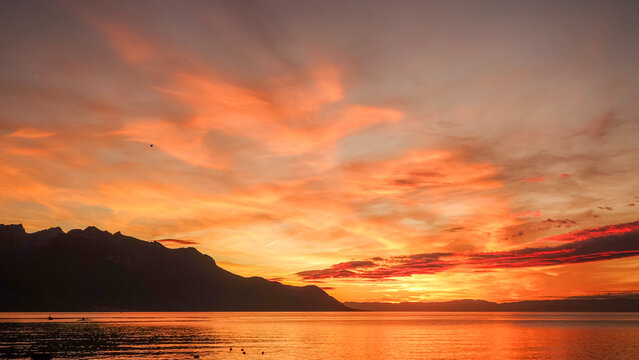Sunset over calm lake during golden hour