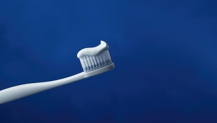 Dental hygiene tools arranged on a dark blue backdrop, focusing on oral care and cleanliness