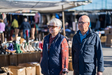 Seniors enjoying a local second-hand market outdoors