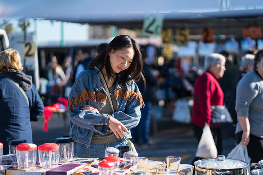 Young woman browsing items at a local flea market