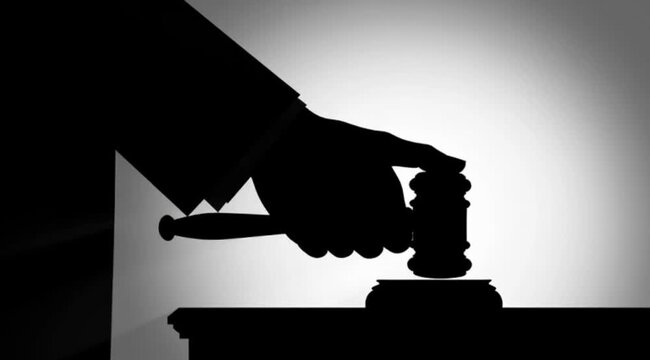 Judge's Hand Striking Gavel Silhouette Symbolizing Justice and Legal Authority