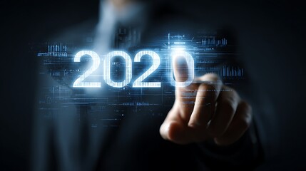 Businessman activating futuristic holographic projection of 2020 with finger touch in dark background