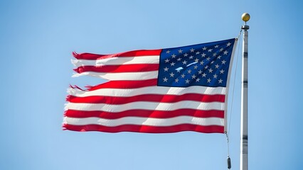 Obraz premium American flag waving on a flagpole against a clear blue sky stars