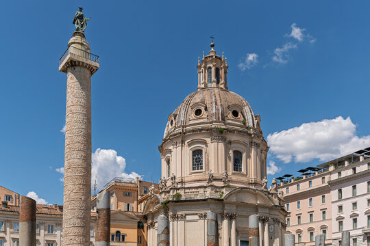 Italy - Rome - Trajan's Column - The ancient victory column with a baroque church dome forms part of the Imperial Forums archaeological site panorama.