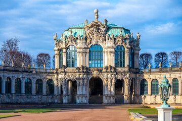 People visit Zwinger Palace in Dresden, Germany during the Christmas season. The complex features beautiful gardens and historic architecture.