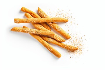 Crispy grissini breadsticks with sesame seeds scattering on a clean white surface