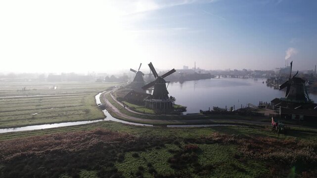 Aerial establishing shot of Zaanse Schans windmills and countryside