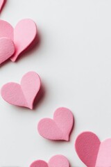 Obraz premium Pink foam hearts arranged diagonally on a white background. Concept Romantic flat lay, Pink foam hearts, Diagonal arrangement, Valentine's decor, Minimalist white background