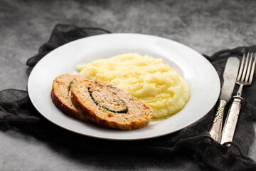 Delicious sliced chicken roll with spinach and cheese and mashed potatos