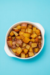 Fried potato in white bowl