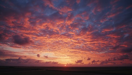 Colorful sunset sky with fluffy clouds in red orange pink and blue shades, ideal for editorial header backgrounds