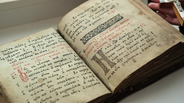 Turning through pages of Slavic Gospel, old pages with candle wax stains, Orthodox holy Bible for Christians, psalter with psalms. Cyrillic Church Slavonic. 