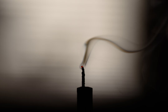 Simple smoke trail from an extinguished candle wick on dark background
