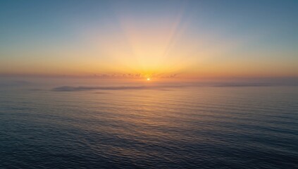 Fototapeta premium Morning sun casting orange hues over calm waters, highlighting a serene seascape, World Oceans Day