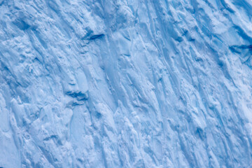 Extreme closeup of of a blue iceberg in Northeast Greenland National Park. Abstract background ice texture.