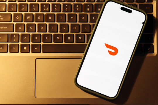 iPhone display with  DoorDash app, food and grocery delivery service.