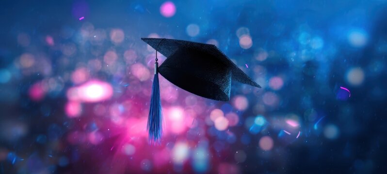 The graduation cap floating above colorful bokeh lights celebrating academic achievement