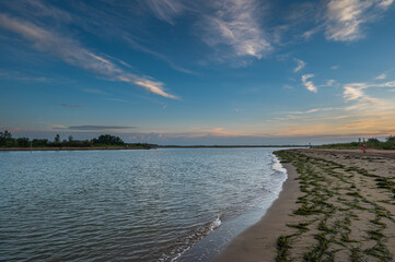 Obraz premium summer sunrise where the lagoon meets the sea, Bibione Pineda, Venice