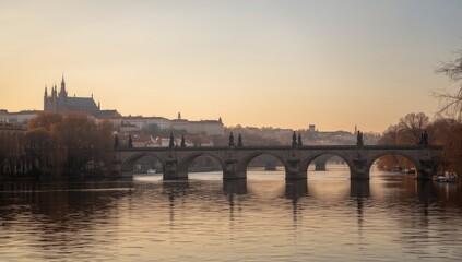 Fototapeta premium Historic Charles bridge with Karluv most and tower in Prague at dawn, autumnal cityscape, seasonal change