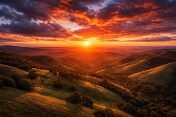Fototapeta premium Spectacular elevated shot featuring vibrant sunset and soft hills