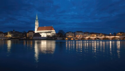 Obraz premium Night scene of a church in Ljubljana with city lights, river, and bridge, urban architecture, European travel destination, Balkans