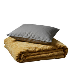 Gray pillow on folded golden blanket