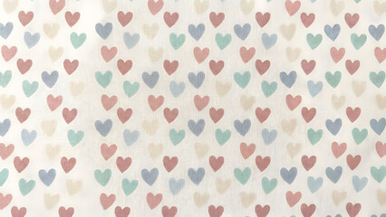 A serene pattern of pastel hearts on a soft fabric background viewed from above