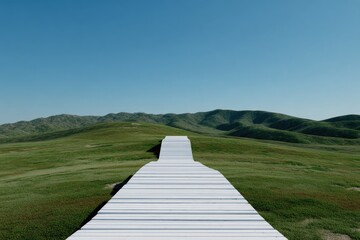 White path stretches through verdant field towards rolling hills under clear, azure sky