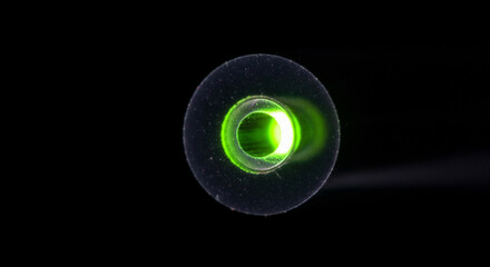 Doped fiber amplification process shows light entering and amplifying in fiber core during scientific experiment