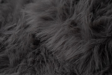Obraz premium Detailed textured background showing a close up of luxurious soft dark grey artificial fur fabric